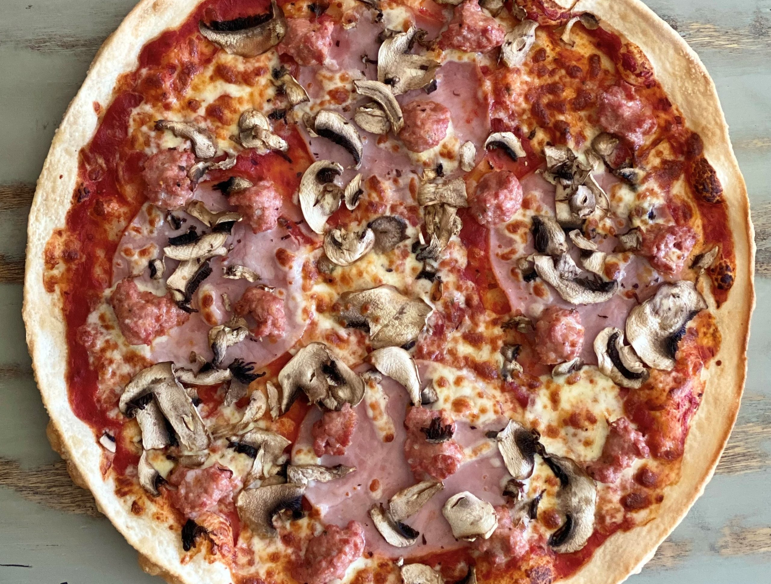 Capricciosa pizza. Ham, mushroom, Italian sausage, oregano and chilli flakes. Made In Italy Sydney